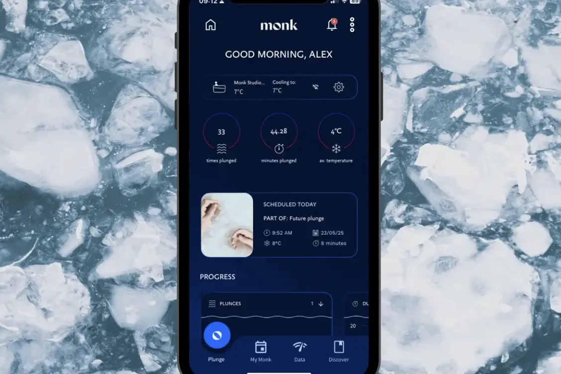 The Monk app on a phone, showing plunge count, minutes and average temperature against a background of ice